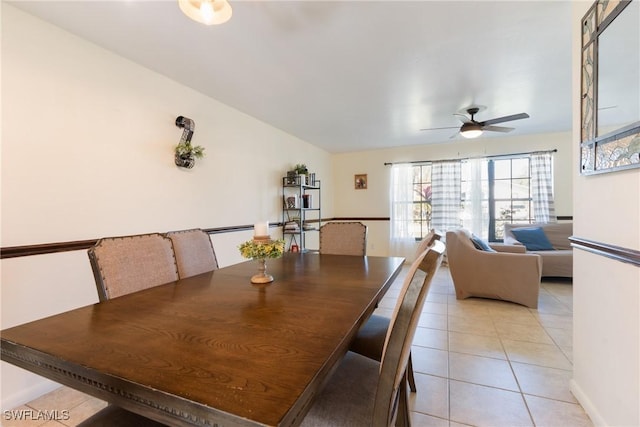 tiled dining space with ceiling fan