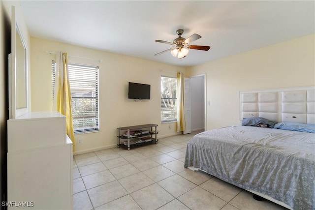 tiled bedroom with multiple windows and ceiling fan