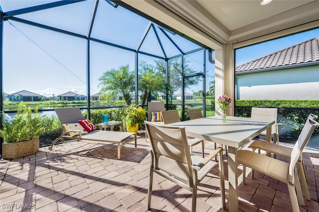 view of patio / terrace with a water view and glass enclosure