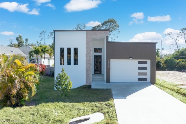 modern home with a garage and a front lawn