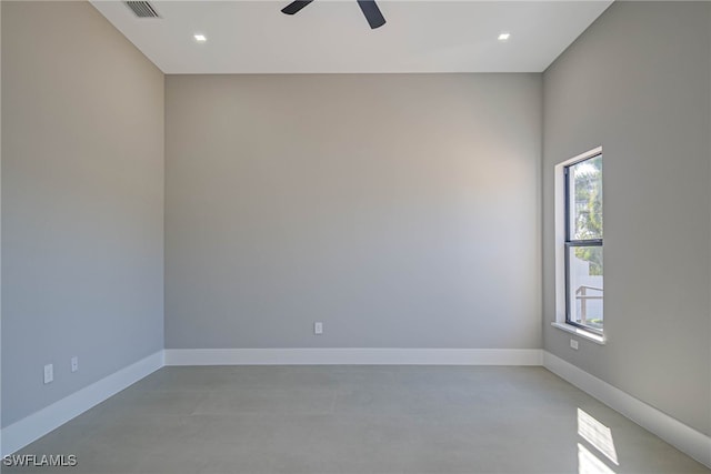 empty room with concrete floors and ceiling fan