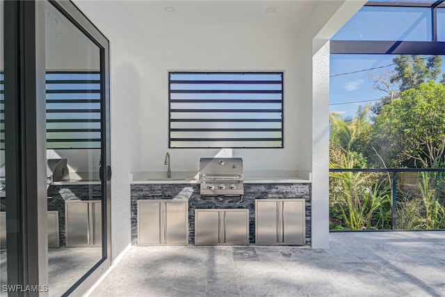 view of patio / terrace featuring area for grilling, a grill, and sink