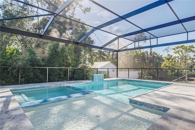 view of pool with an in ground hot tub, a lanai, and a patio area