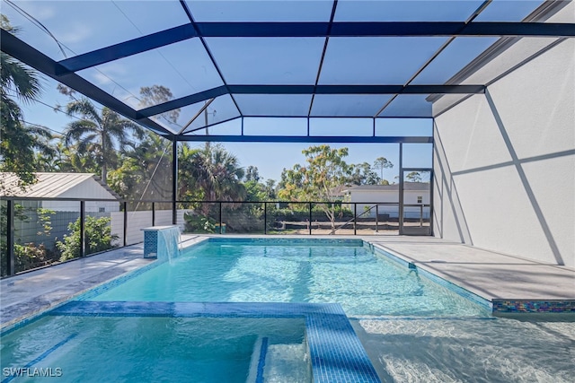 view of pool with a patio area and glass enclosure