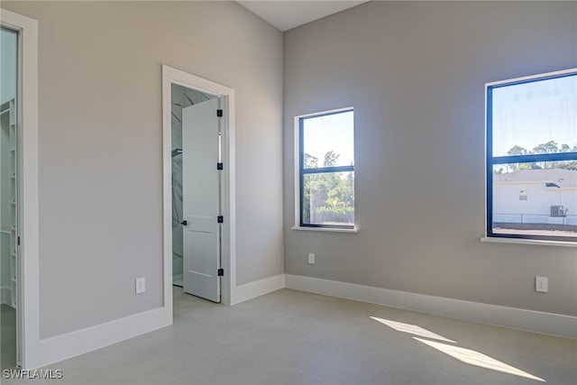 unfurnished bedroom with a walk in closet