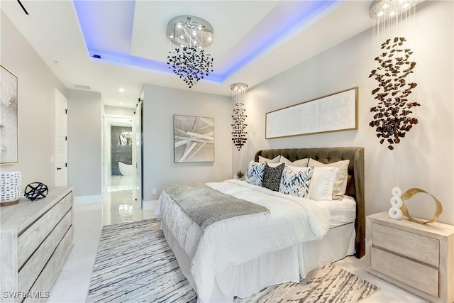 bedroom with an inviting chandelier and a tray ceiling