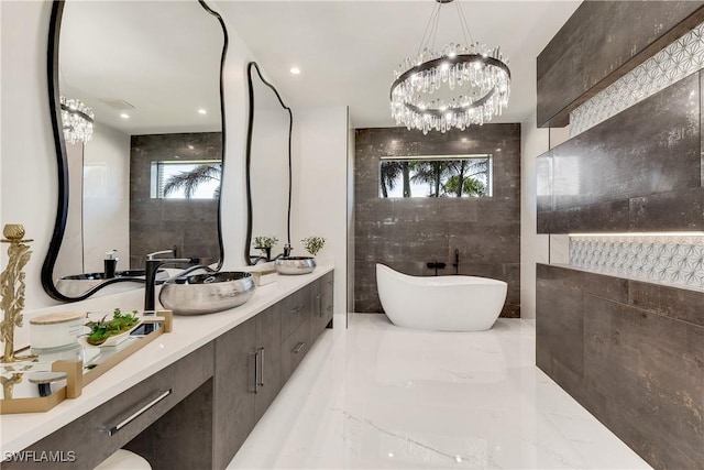 bathroom with a washtub, vanity, and tile walls