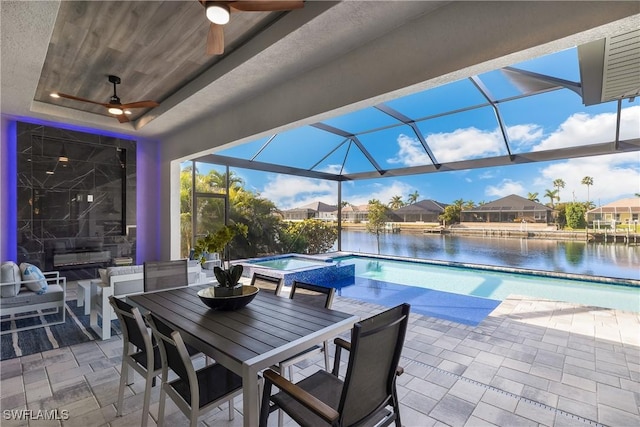 view of patio featuring a pool with hot tub, ceiling fan, glass enclosure, and a water view