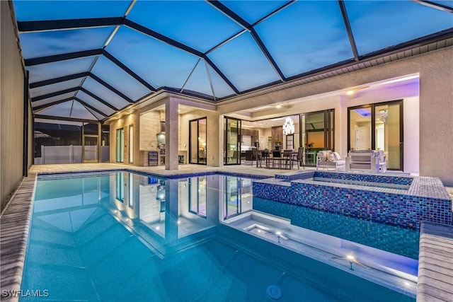 view of swimming pool featuring an in ground hot tub, a lanai, and a patio