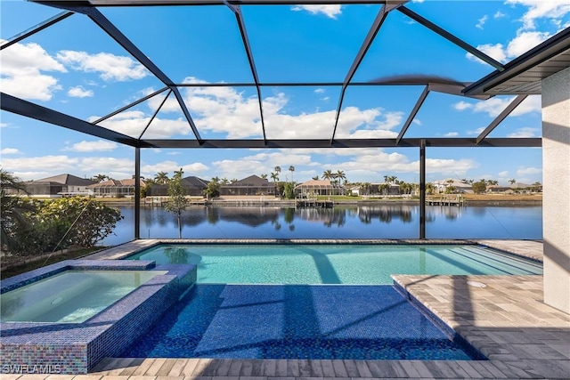 view of pool with an in ground hot tub, a water view, a lanai, and a patio area