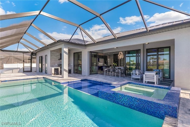 view of swimming pool with an in ground hot tub, glass enclosure, and a patio area