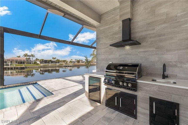 view of patio with sink, a lanai, a water view, a grill, and area for grilling