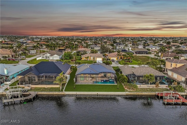 aerial view at dusk with a water view