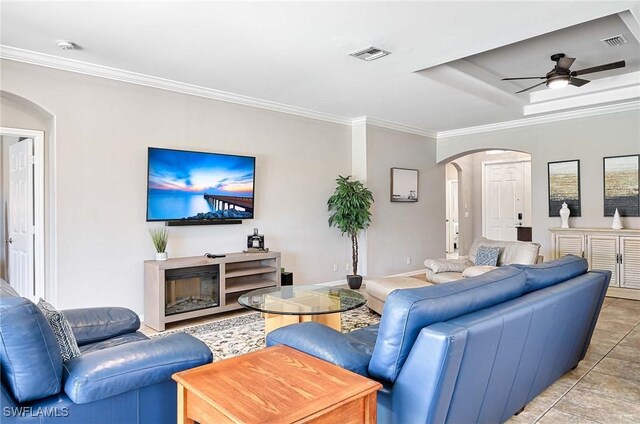 living room with crown molding, ceiling fan, and light tile patterned flooring