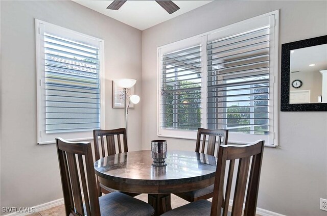 dining space featuring ceiling fan and baseboards