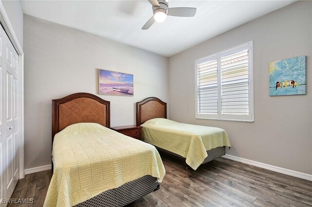 bedroom featuring dark hardwood / wood-style floors, ceiling fan, and a closet