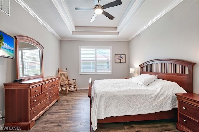 bedroom with multiple windows, ornamental molding, dark hardwood / wood-style floors, and a tray ceiling