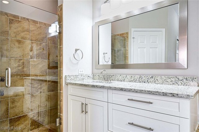 bathroom featuring vanity and an enclosed shower