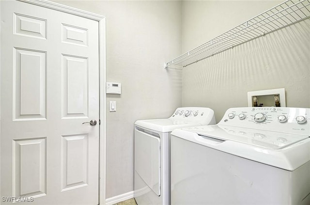 laundry room with separate washer and dryer