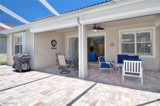 view of patio with area for grilling and ceiling fan