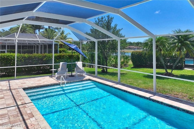 view of pool featuring a patio, a water view, glass enclosure, and a lawn