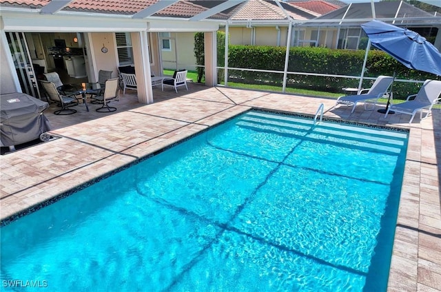 view of pool with a lanai and a patio area