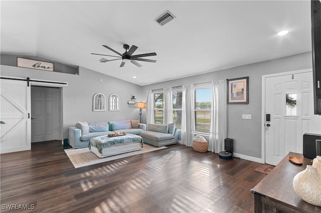 living room with vaulted ceiling, a barn door, dark hardwood / wood-style floors, and ceiling fan