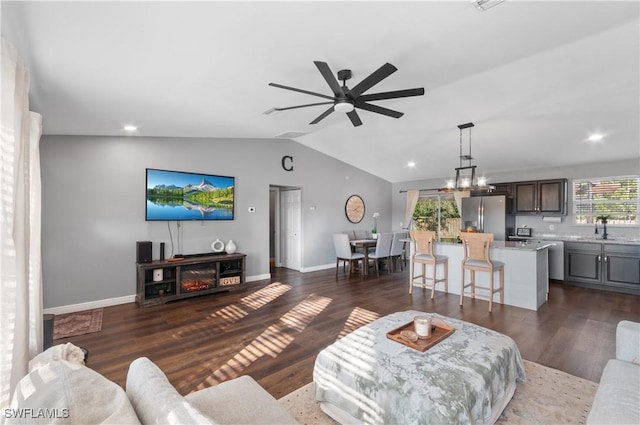 living room with lofted ceiling, sink, ceiling fan with notable chandelier, and dark hardwood / wood-style flooring