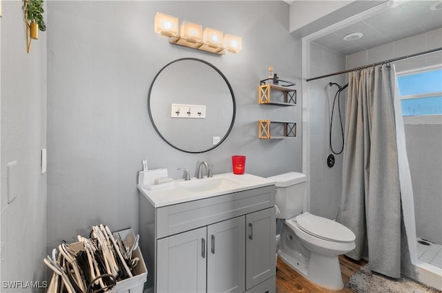 bathroom with vanity, toilet, a shower with shower curtain, and wood-type flooring