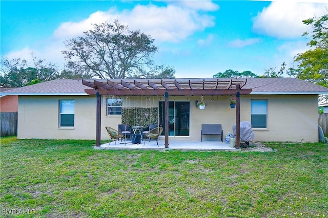 back of property with a yard, a pergola, and a patio