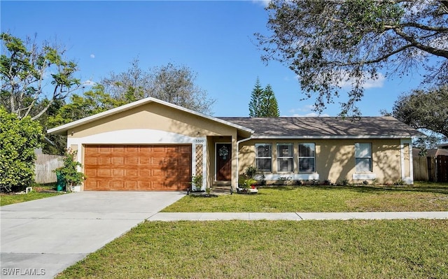 view of front of property with a garage, fence, concrete driveway, stucco siding, and a front yard