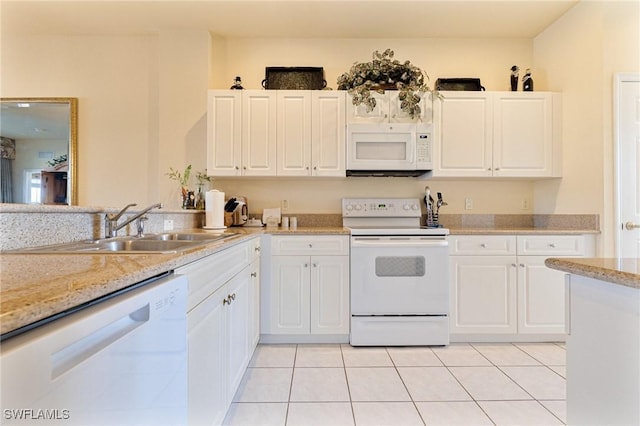 kitchen featuring white cabinetry, light tile patterned floors, and white appliances