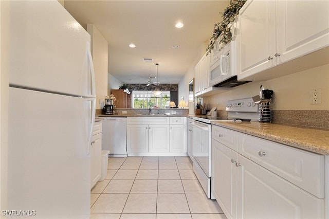 kitchen featuring white cabinetry, sink, light tile patterned floors, kitchen peninsula, and white appliances