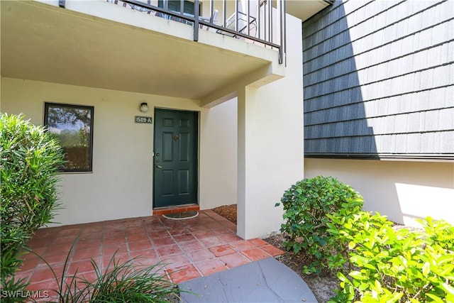 doorway to property featuring a patio area and a balcony