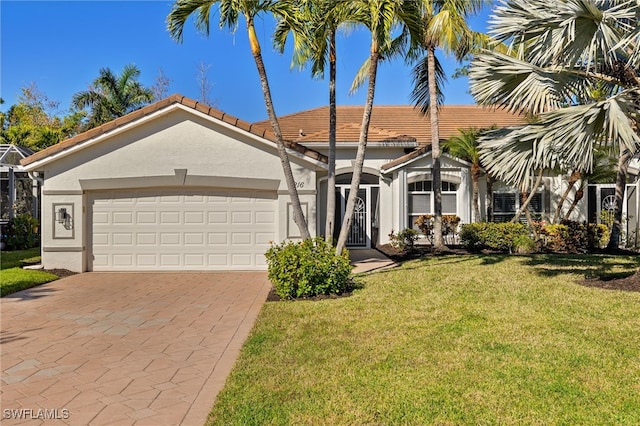 view of front facade with a garage and a front lawn