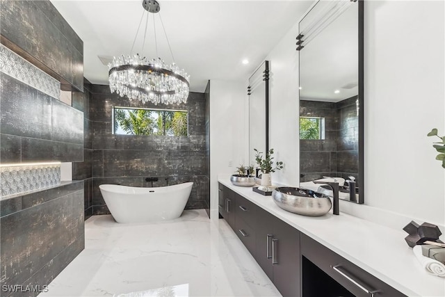 bathroom with vanity, a bath, and tile walls