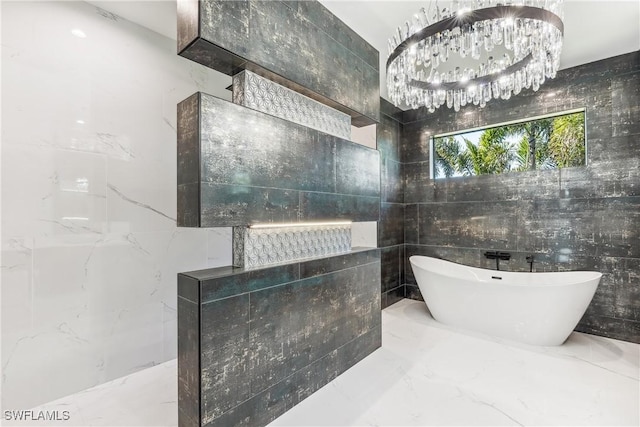 bathroom with a chandelier, a bathtub, and tile walls