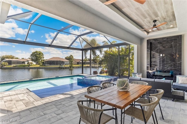 view of pool with an in ground hot tub, glass enclosure, an outdoor living space, a water view, and a patio area