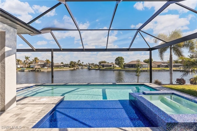 view of swimming pool with an in ground hot tub, a water view, and glass enclosure