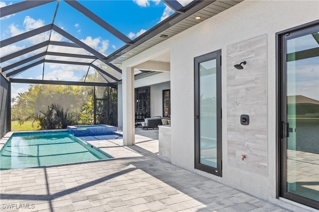 view of pool with an in ground hot tub, a lanai, and a patio