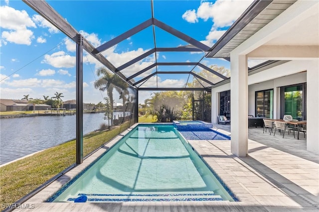 view of swimming pool featuring a patio area, glass enclosure, and a water view