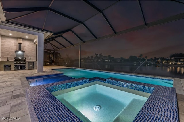 view of pool with an in ground hot tub, area for grilling, a lanai, and a patio area