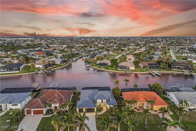 aerial view at dusk with a water view