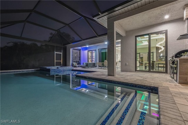 view of swimming pool with a lanai and a patio