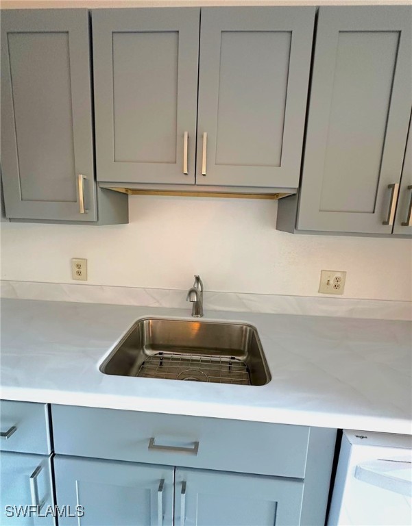 kitchen featuring gray cabinets and sink