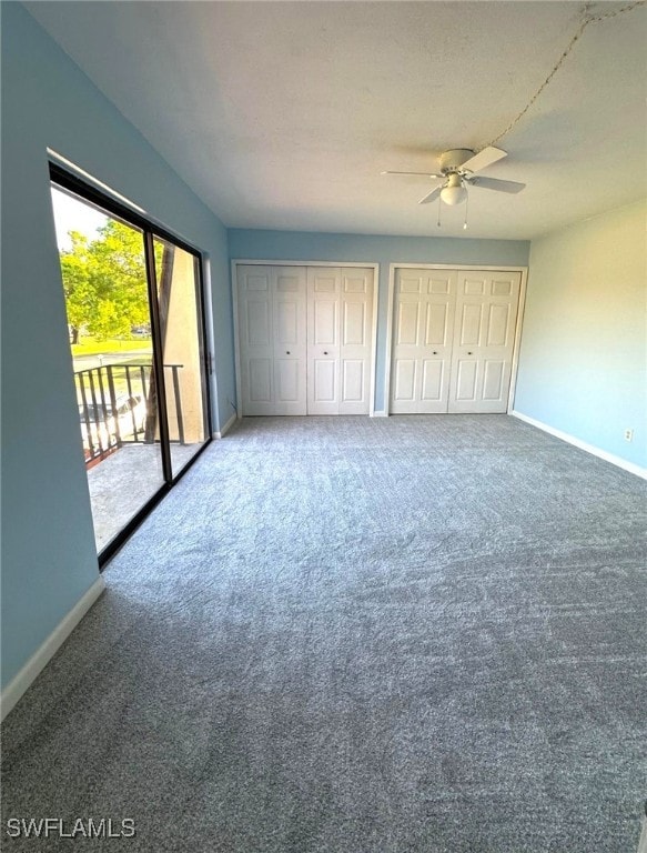 unfurnished bedroom featuring two closets, access to outside, carpet, and ceiling fan