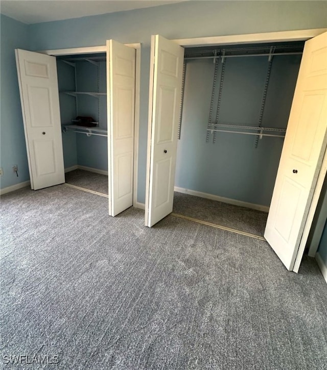 unfurnished bedroom featuring a closet and dark colored carpet