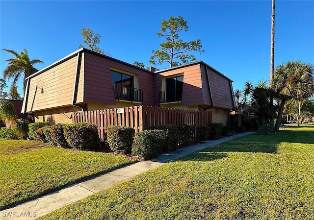 view of side of home with a yard