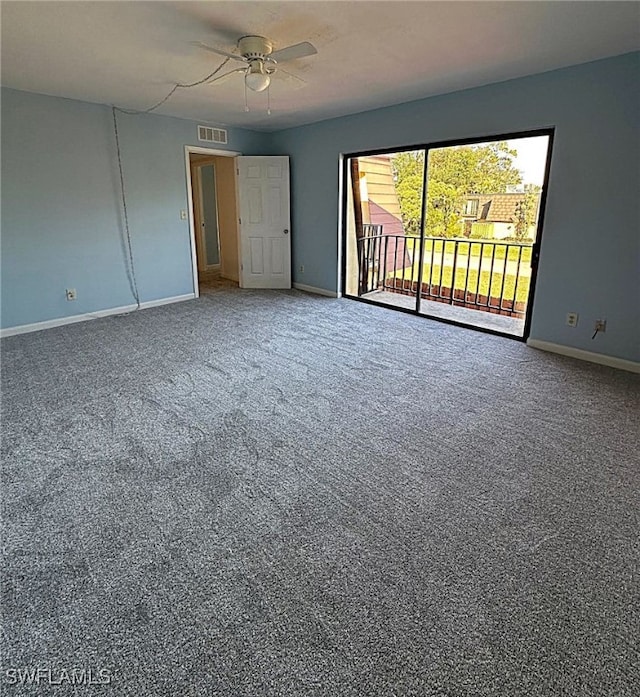 carpeted spare room featuring ceiling fan