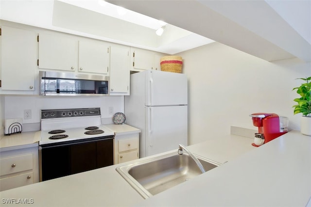 kitchen with sink, electric range, white cabinets, and white refrigerator